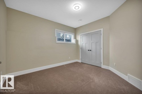 Unfurnished bedroom featuring carpet flooring, a closet, and a textured ceiling - 6221 167A Avenue, Edmonton, AB - Indoor Photo Showing Other Room