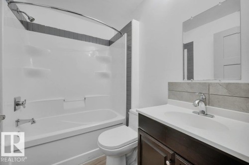 Bathroom featuring  shower combination, vanity, and tasteful backsplash - 6221 167A Avenue, Edmonton, AB - Indoor Photo Showing Bathroom