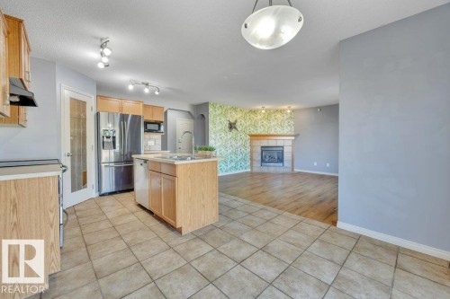128 Southfork Drive, Leduc, AB - Indoor Photo Showing Kitchen With Fireplace
