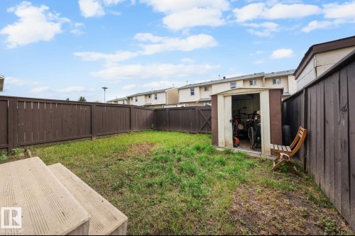 Fenced backyard featuring a storage unit and a patio area - 285 Harrison Drive, Edmonton, AB - Outdoor