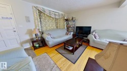 Living area with wood finished floors and a textured ceiling - 