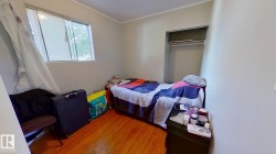 Bedroom featuring wood finished floors and ornamental molding - 