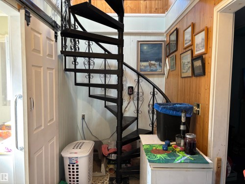 Stairway featuring wood walls - 140 Russel Drive, Rural St. Paul County, AB - Indoor Photo Showing Other Room