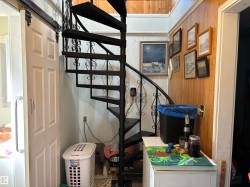 Stairway featuring wood walls - 
