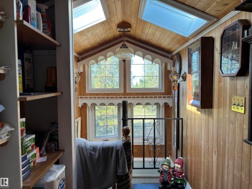 Doorway to outside with wood ceiling, lofted ceiling, a skylight, and wood walls - 140 Russel Drive, Rural St. Paul County, AB - Indoor Photo Showing Other Room