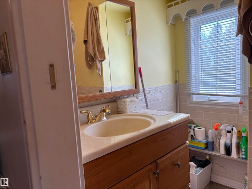 Bathroom with vanity and tile walls - 140 Russel Drive, Rural St. Paul County, AB - Indoor Photo Showing Bathroom