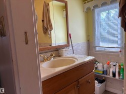 Bathroom with vanity and tile walls - 