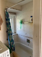 Full bathroom with washer / clothes dryer and shower / bathtub combination with curtain - 