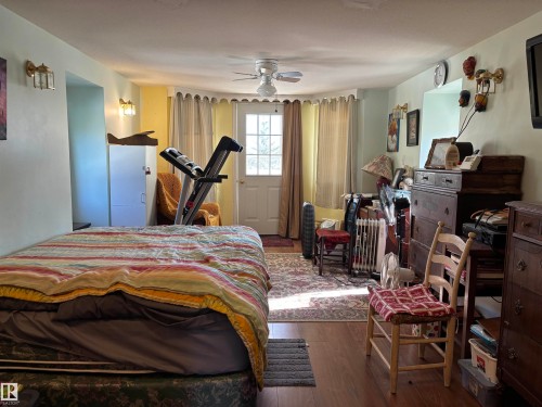 Bedroom featuring wood finished floors and a ceiling fan - 140 Russel Drive, Rural St. Paul County, AB - Indoor Photo Showing Bedroom