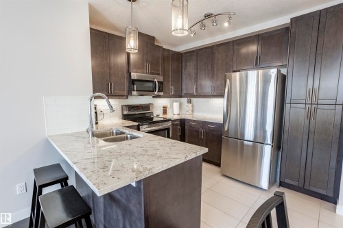 307 5151 Windermere Boulevard Nw, Edmonton, AB - Indoor Photo Showing Kitchen With Double Sink With Upgraded Kitchen