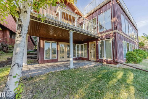 Back of property with a patio, a balcony, a lawn, and french doors - 1602 106 Street, Edmonton, AB - Outdoor With Deck Patio Veranda