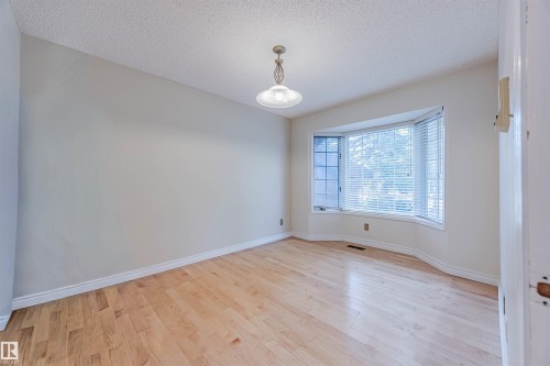 Spare room with a textured ceiling and light wood-style flooring - 1602 106 Street, Edmonton, AB - Indoor Photo Showing Other Room