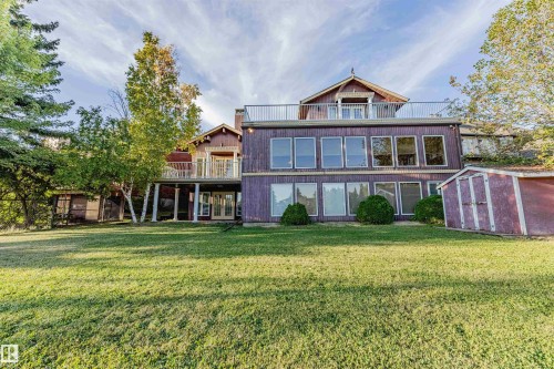Back of house featuring a storage shed, a balcony, a lawn, and a patio area - 1602 106 Street, Edmonton, AB - Outdoor With Deck Patio Veranda