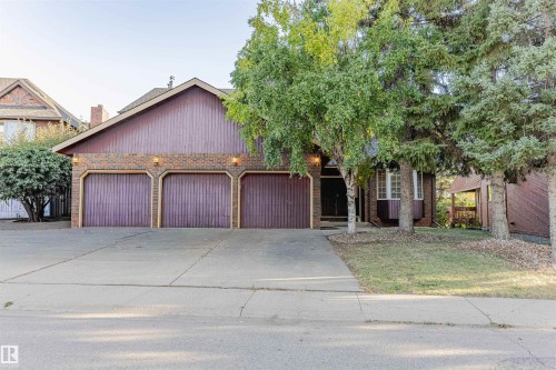 View of front of property featuring brick siding, driveway, and a garage - 1602 106 Street, Edmonton, AB - Outdoor