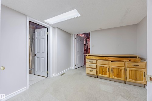 Unfurnished bedroom featuring light colored carpet and a textured ceiling - 1602 106 Street, Edmonton, AB - Indoor Photo Showing Other Room