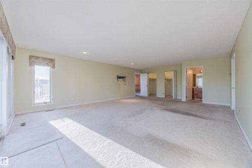 Unfurnished bedroom with a walk in closet, carpet flooring, recessed lighting, and connected bathroom - 1602 106 Street, Edmonton, AB - Indoor Photo Showing Other Room