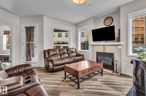 104 10046 110 Street, Edmonton, AB - Indoor Photo Showing Living Room With Fireplace