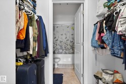 Spacious closet with light tile patterned floors - 