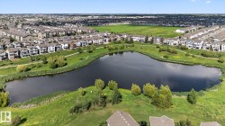Aerial view of property's location featuring nearby suburban area and a large body of water - 