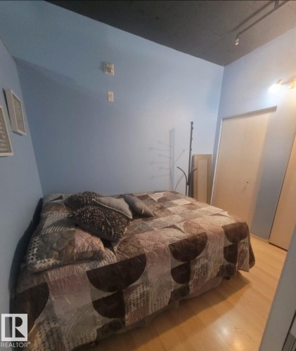 Bedroom with wood finished floors - 1704 10024 Jasper Avenue, Edmonton, AB - Indoor Photo Showing Bedroom
