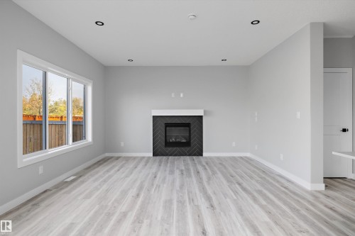 36 Maple Crescent, Gibbons, AB - Indoor Photo Showing Living Room With Fireplace