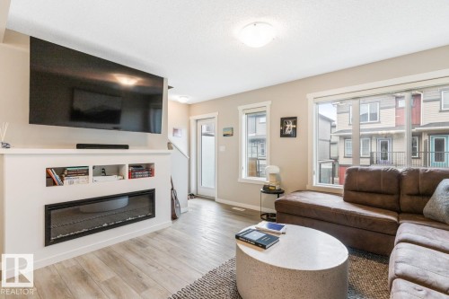 110 1530 Tamarack Boulevard, Edmonton, AB - Indoor Photo Showing Living Room With Fireplace