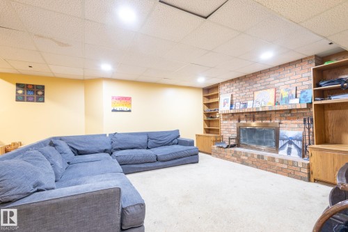 410 Olsen Close, Edmonton, AB - Indoor Photo Showing Basement With Fireplace