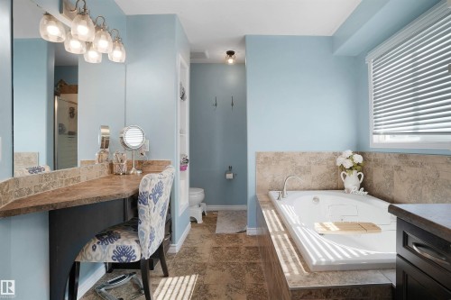 Full bath with a whirlpool tub, a shower stall, and vanity - 20705 56A Avenue, Edmonton, AB - Indoor Photo Showing Bathroom