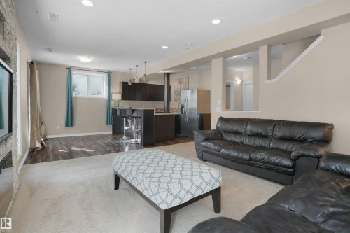 Living area with wood finished floors and recessed lighting - 20705 56A Avenue, Edmonton, AB - Indoor Photo Showing Living Room