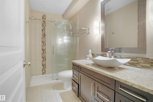 Bathroom with vanity, a stall shower, light tile patterned floors, and tasteful backsplash - 20705 56A Avenue, Edmonton, AB - Indoor Photo Showing Bathroom