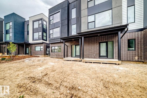Modern townhome exteriors featuring varied siding materials and large windows - 68 5 Rondeau Drive, St. Albert, AB - Outdoor