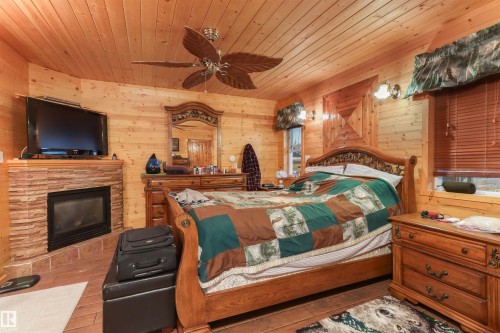 4836 A 53 Ave & 4836 B 53 Avenue, Cynthia, AB - Indoor Photo Showing Bedroom With Fireplace