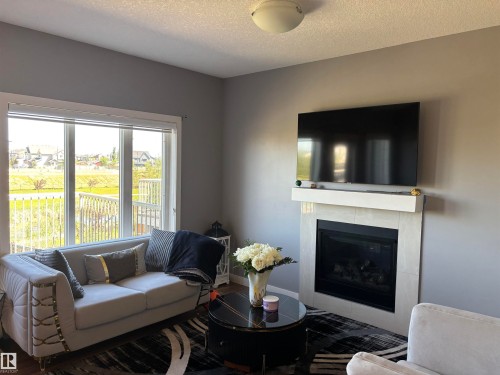 6694 Cardinal Road, Edmonton, AB - Indoor Photo Showing Living Room With Fireplace