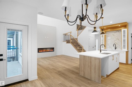 17 Axelwood Crescent, Spruce Grove, AB - Indoor Photo Showing Kitchen With Fireplace