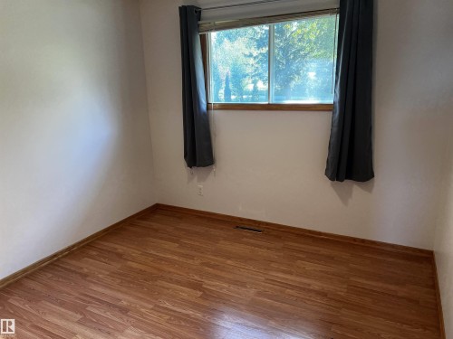 Unfurnished room featuring wood finished floors and baseboards - 74038 Birch Avenue, Widewater, AB - Indoor Photo Showing Other Room