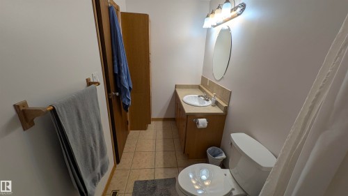 Bathroom featuring light tile patterned flooring and vanity - 74038 Birch Avenue, Widewater, AB - Indoor Photo Showing Bathroom