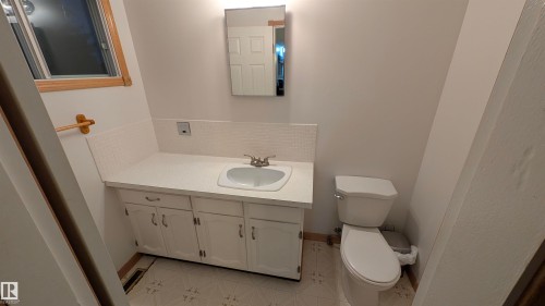 Bathroom featuring vanity, tasteful backsplash, and light tile patterned flooring - 74038 Birch Avenue, Widewater, AB - Indoor Photo Showing Bathroom
