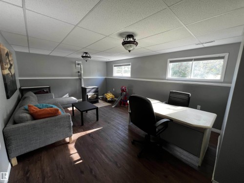 Office space with a drop ceiling and dark wood-style flooring - 74038 Birch Avenue, Widewater, AB - Indoor