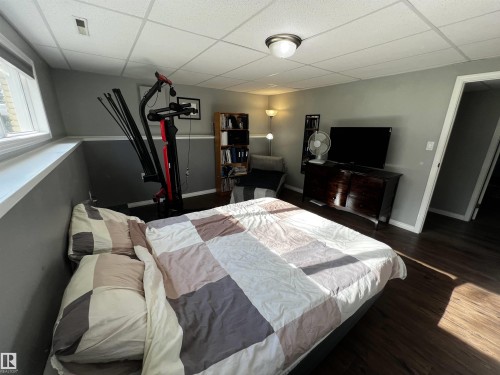 Bedroom featuring a paneled ceiling and dark wood finished floors - 74038 Birch Avenue, Widewater, AB - Indoor Photo Showing Bedroom