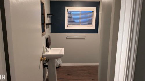 Bathroom with baseboards and dark wood-style flooring - 74038 Birch Avenue, Widewater, AB - Indoor