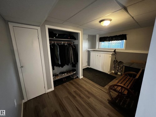 Mudroom featuring a paneled ceiling and dark wood-type flooring - 74038 Birch Avenue, Widewater, AB - Indoor