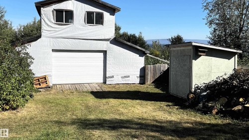 View of side of property with an outbuilding and a garage - 74038 Birch Avenue, Widewater, AB - Outdoor With Exterior