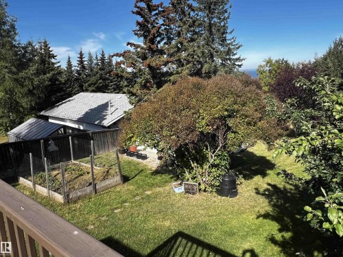 View of green lawn with a vegetable garden - 74038 Birch Avenue, Widewater, AB - Outdoor