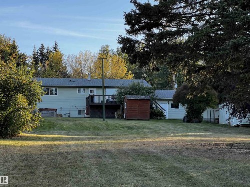 Rear view of property featuring a deck, a lawn, and stairway - 74038 Birch Avenue, Widewater, AB - Outdoor