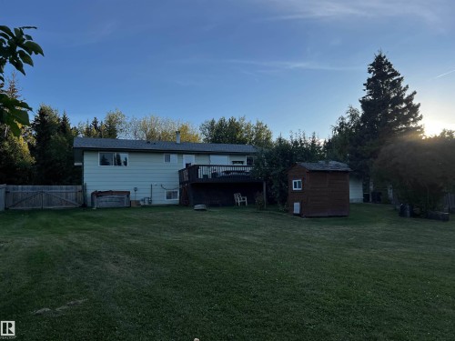 Back of house featuring a shed, a wooden deck, a yard, and a gate - 74038 Birch Avenue, Widewater, AB - Outdoor