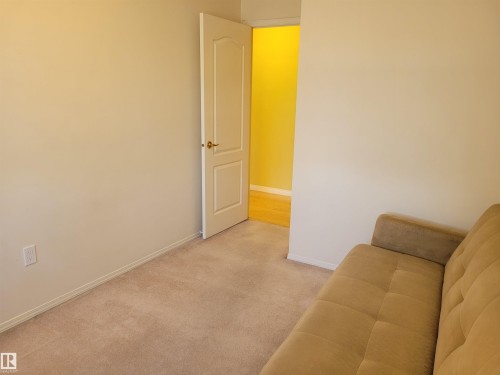 Sitting room featuring light colored carpet and baseboards - 404 13450 114 Avenue, Edmonton, AB - Indoor Photo Showing Other Room