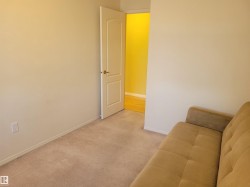 Sitting room featuring light colored carpet and baseboards - 