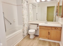 Bathroom featuring shower / tub combo with curtain, vanity - 