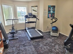 Exercise area with baseboards and carpet floors - 