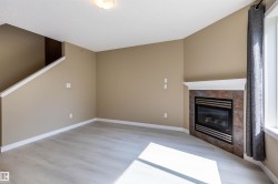 Unfurnished living room with a fireplace and light wood-style flooring - 